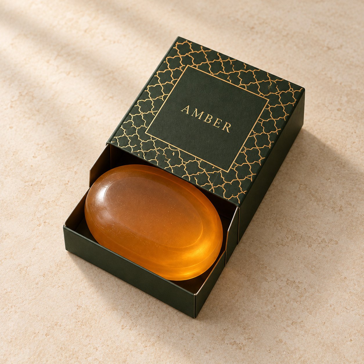 Amber transparent oval soap in a dark green patterned drawer box